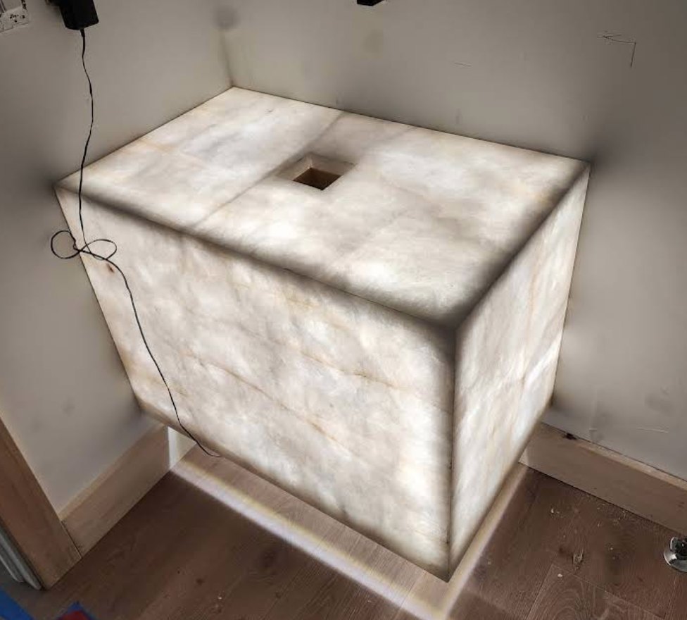 Backlit translucent stone vanity glowing from within