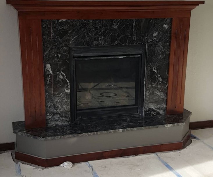 Stained fireplace mantel and surround over a stone hearth