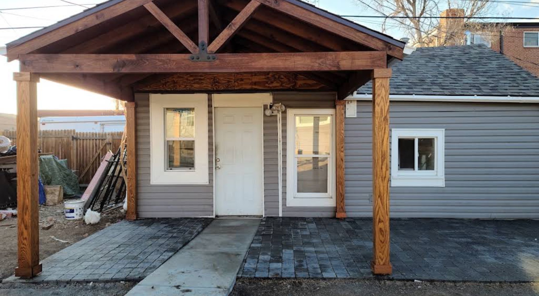 Stained timber gable porch cover over a rear entry
